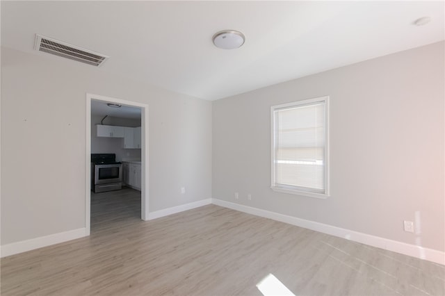 spare room featuring light hardwood / wood-style flooring