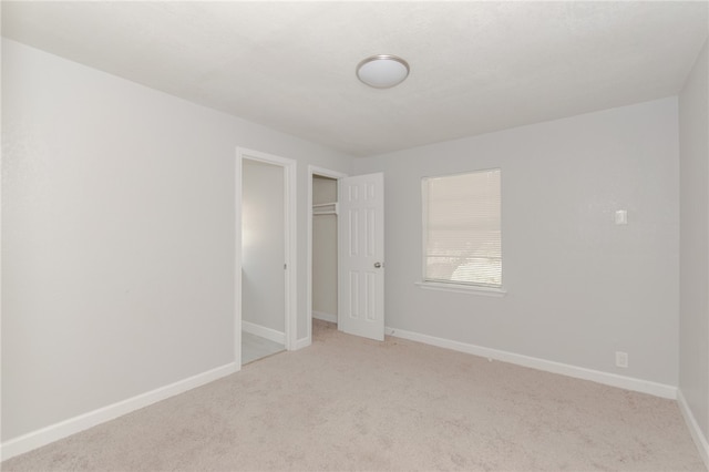 empty room featuring light colored carpet