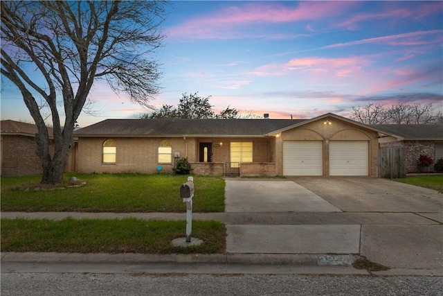 single story home with an attached garage, covered porch, brick siding, a yard, and concrete driveway