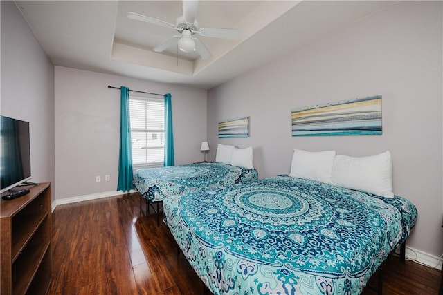 15102 Leeward Dr Unit 502, Corpus Christi, TX 78418 - bedroom with wood finished floors, baseboards, a raised ceiling, and a ceiling fan