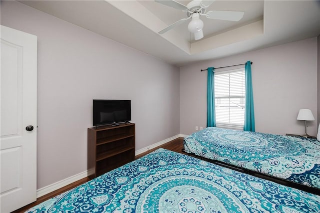 15102 Leeward Dr Unit 502, Corpus Christi, TX 78418 - bedroom with wood finished floors, baseboards, a tray ceiling, and ceiling fan
