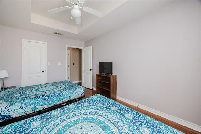 15102 Leeward Dr Unit 502, Corpus Christi, TX 78418 - bedroom with a tray ceiling, wood finished floors, baseboards, and ceiling fan