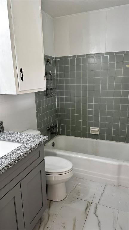 full bathroom featuring marble finish floor, vanity, toilet, and shower / bathtub combination