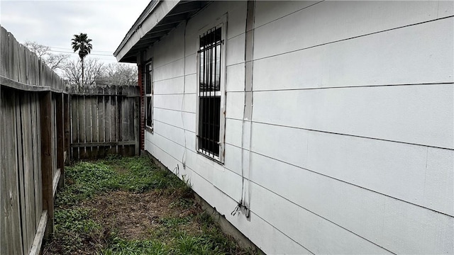 view of side of property featuring fence