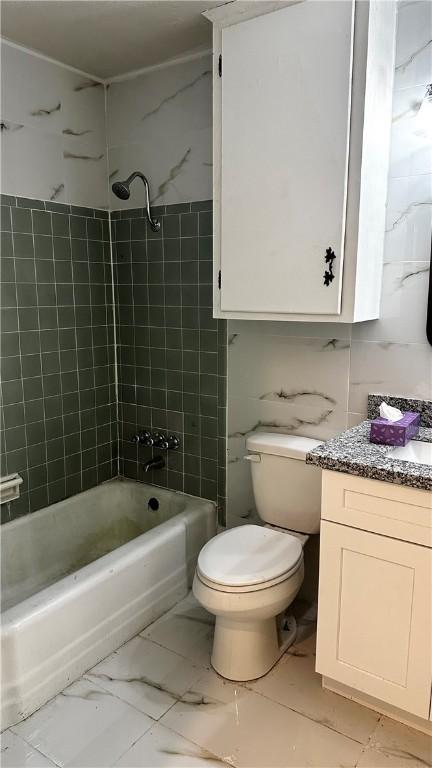 full bath featuring toilet, marble finish floor, tub / shower combination, and vanity