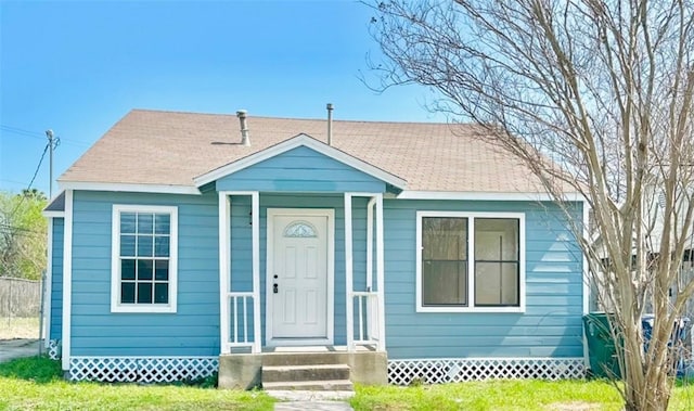 bungalow-style home featuring a front yard