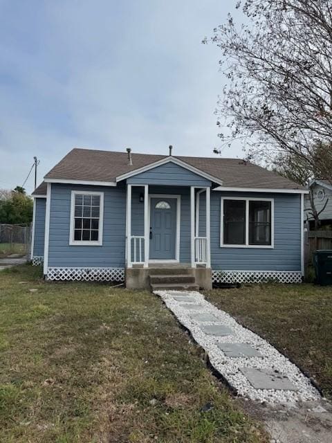 bungalow-style home featuring a front lawn