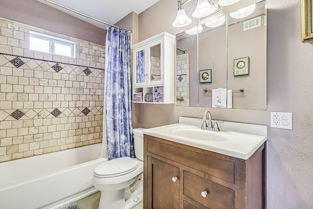 bathroom with visible vents, toilet, vanity, and shower / bath combo