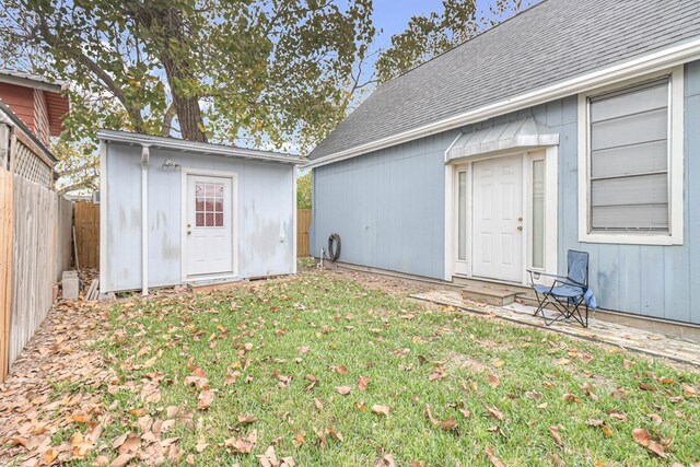 exterior space with a storage unit, an outdoor structure, and a fenced backyard