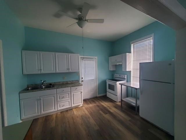 kitchen with white appliances, dark wood finished floors, ceiling fan, a sink, and white cabinetry