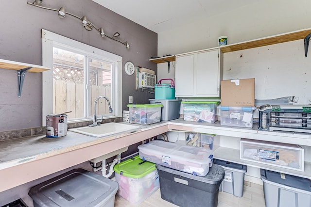 kitchen featuring white cabinetry, open shelves, and a sink