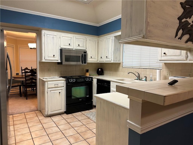 kitchen featuring black appliances, white cabinetry, ornamental molding, and tile countertops