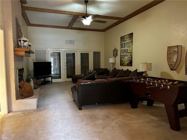 living room with a large fireplace, ceiling fan, french doors, and carpet