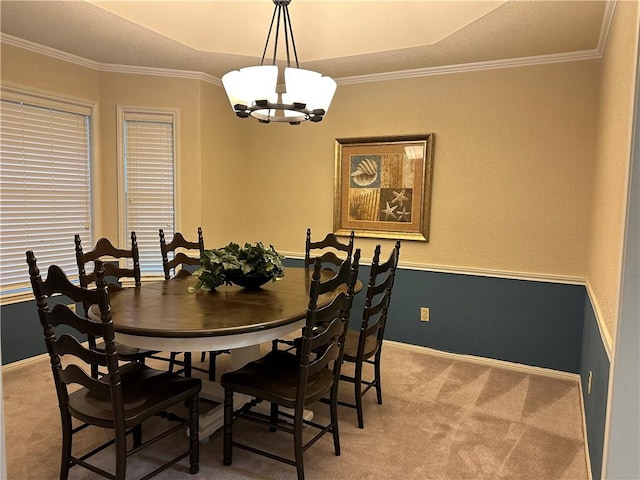 dining area with a chandelier, carpet flooring, and crown molding