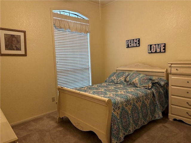 bedroom featuring ornamental molding and dark colored carpet