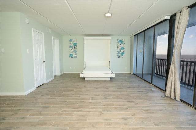 4334 E Ocean Dr Unit 306, Corpus Christi, TX 78404 - unfurnished room featuring light wood finished floors and baseboards