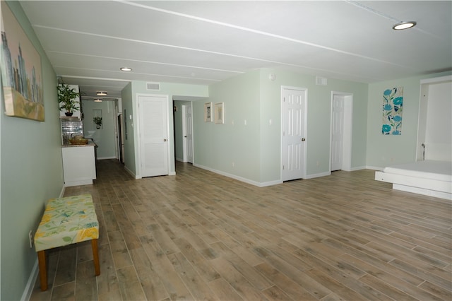 4334 E Ocean Dr Unit 306, Corpus Christi, TX 78404 - unfurnished living room featuring baseboards and wood finished floors