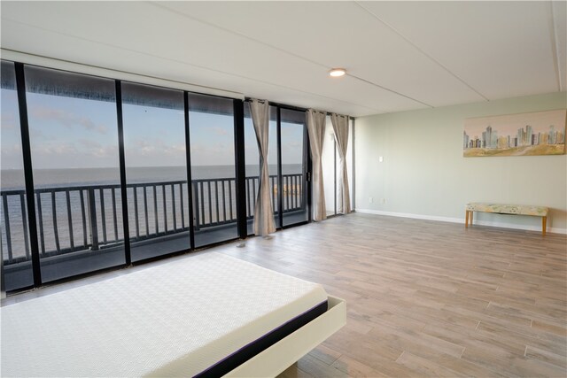 4334 E Ocean Dr Unit 306, Corpus Christi, TX 78404 - spare room with wood finished floors and a water view