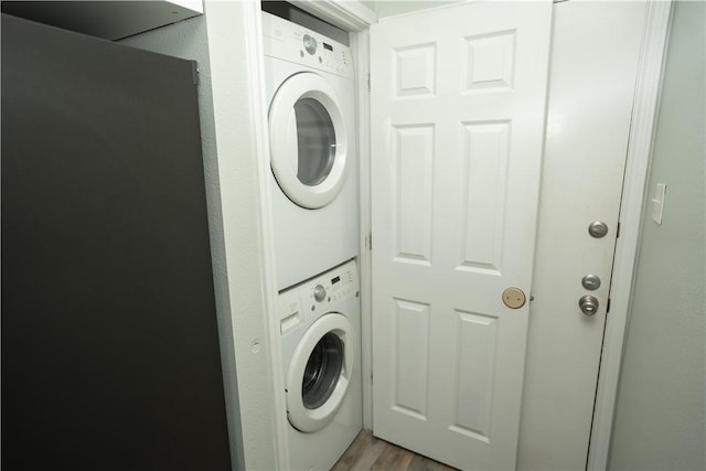 4334 E Ocean Dr Unit 306, Corpus Christi, TX 78404 - washroom with stacked washer and clothes dryer and wood finished floors