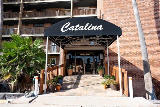 4334 E Ocean Dr Unit 306, Corpus Christi, TX 78404 - doorway to property with brick siding