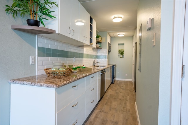 4334 E Ocean Dr Unit 306, Corpus Christi, TX 78404 - kitchen featuring open shelves, decorative backsplash, dishwasher, light wood finished floors, and white cabinetry