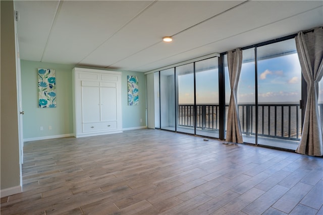 4334 E Ocean Dr Unit 306, Corpus Christi, TX 78404 - unfurnished room featuring wood finished floors and floor to ceiling windows