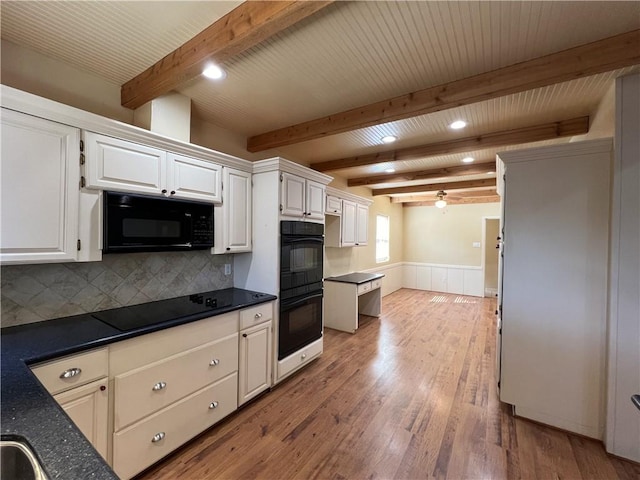 kitchen with decorative backsplash, light wood-type flooring, black appliances, beam ceiling, and white cabinets