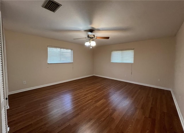 unfurnished room with ceiling fan and dark wood-type flooring