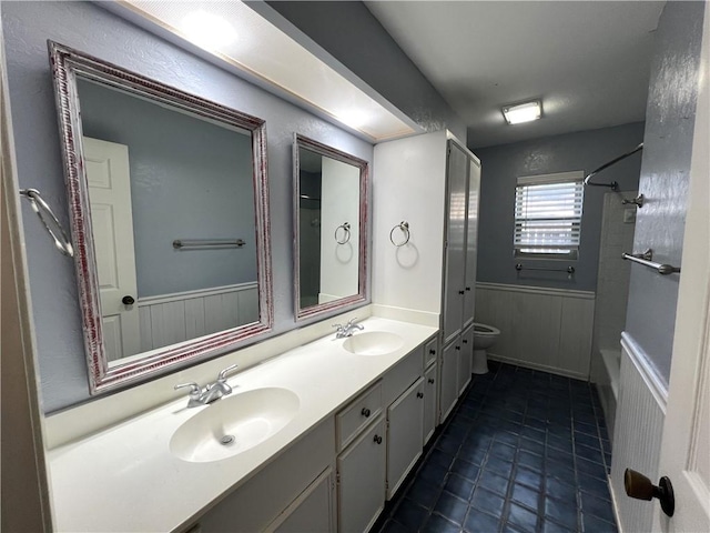 bathroom with tile patterned floors, vanity, toilet, and walk in shower