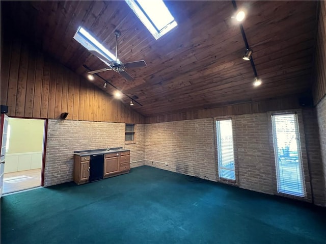 interior space featuring wood walls, wooden ceiling, dark carpet, and track lighting