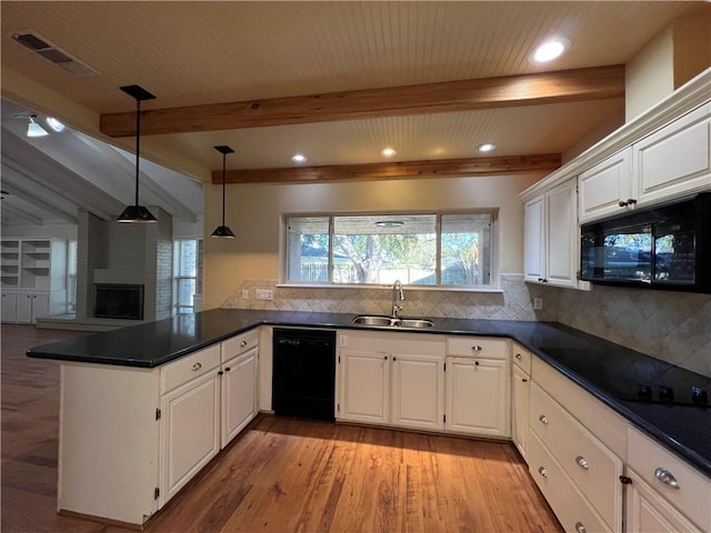 kitchen with sink, hanging light fixtures, kitchen peninsula, white cabinets, and black appliances