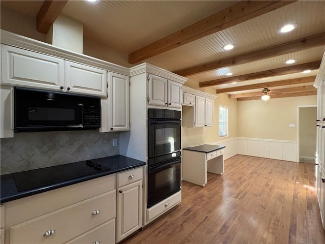 kitchen with backsplash, black appliances, beamed ceiling, white cabinets, and light hardwood / wood-style floors