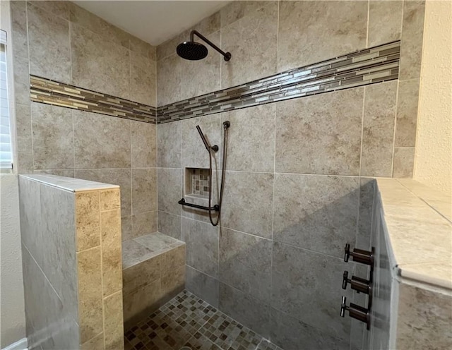 bathroom with tiled shower