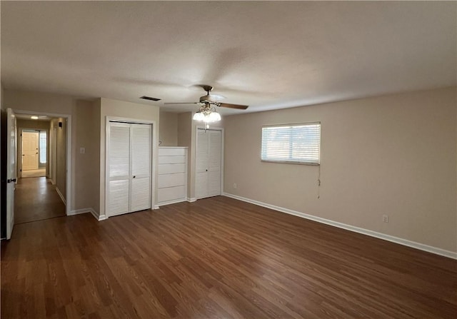 unfurnished bedroom featuring ceiling fan and dark hardwood / wood-style floors