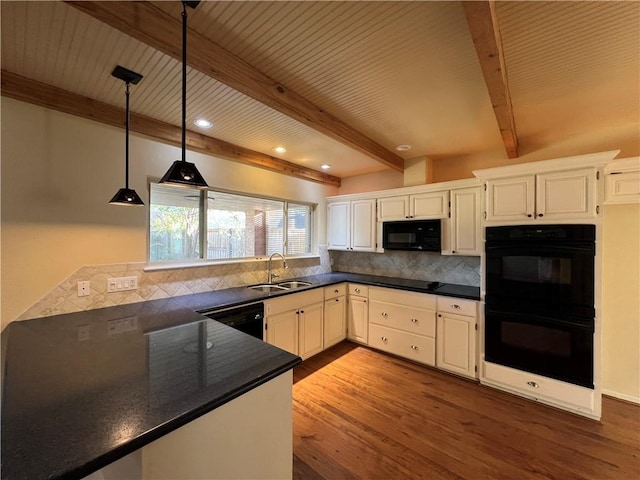 kitchen featuring black appliances, white cabinetry, and sink