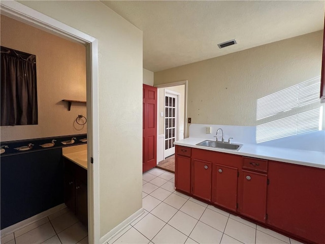 kitchen featuring sink and light tile patterned floors