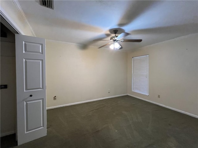 carpeted spare room with ceiling fan and crown molding