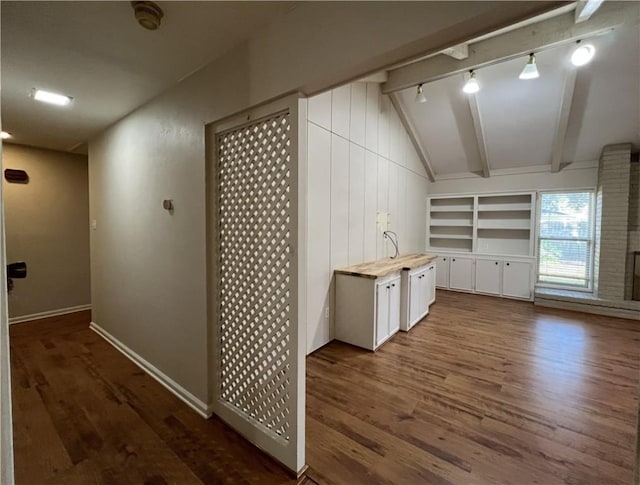 bonus room featuring vaulted ceiling with beams, dark hardwood / wood-style floors, and sink