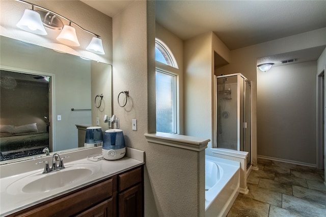 bathroom featuring independent shower and bath and vanity