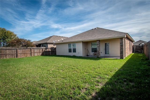 rear view of house with a lawn