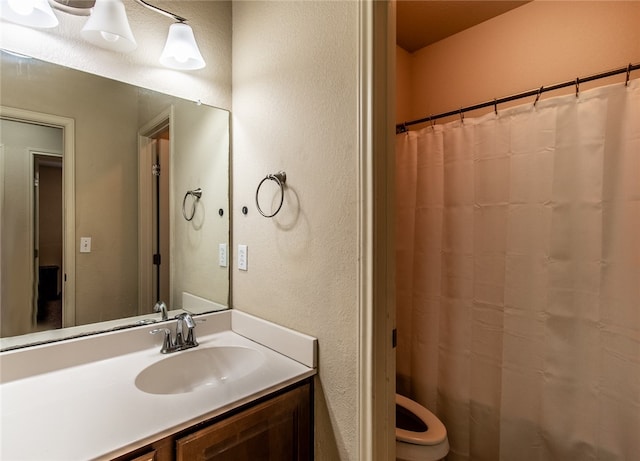 bathroom featuring toilet and vanity