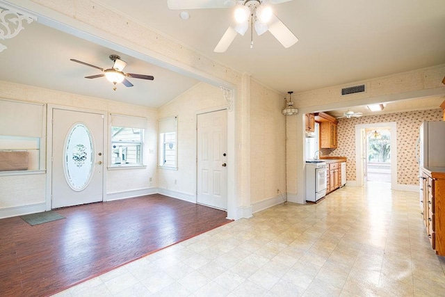 711 E Lott St, Beeville, TX 78102 - entryway featuring a ceiling fan, lofted ceiling, wallpapered walls, light floors, and baseboards