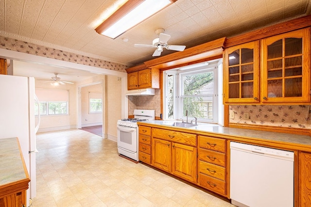 711 E Lott St, Beeville, TX 78102 - kitchen with white appliances, a ceiling fan, light floors, glass insert cabinets, and brown cabinetry