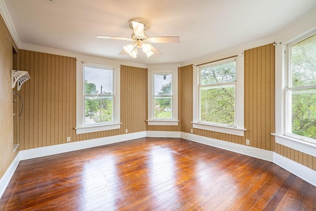 711 E Lott St, Beeville, TX 78102 - spare room featuring hardwood / wood-style flooring, healthy amount of natural light, crown molding, baseboards, and ceiling fan
