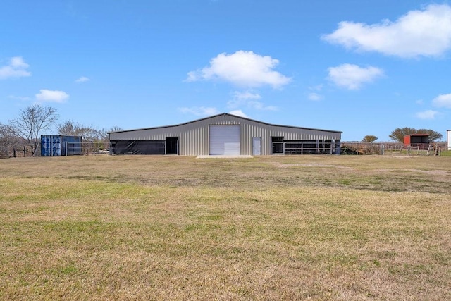 view of pole building featuring a lawn