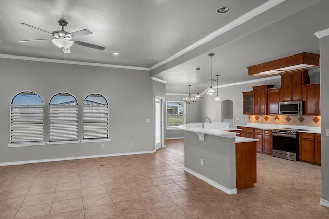 kitchen with glass insert cabinets, stainless steel appliances, light countertops, brown cabinets, and decorative light fixtures