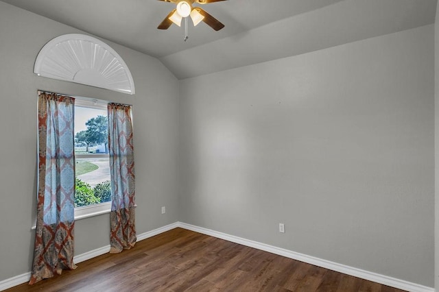 empty room with lofted ceiling, ceiling fan, baseboards, and wood finished floors