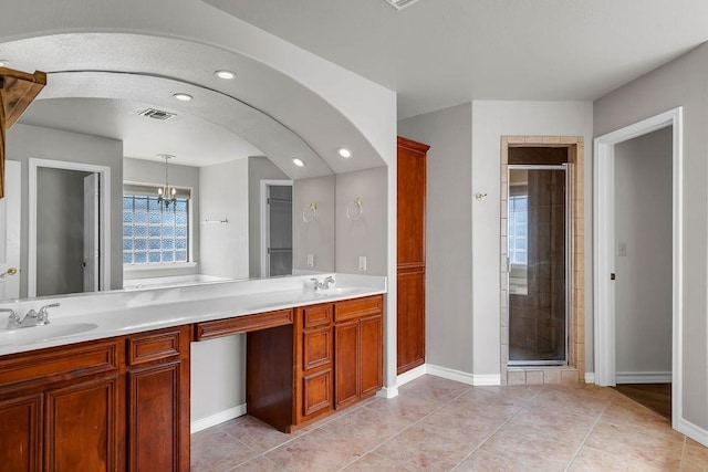 full bath featuring tile patterned flooring, a sink, visible vents, double vanity, and a stall shower