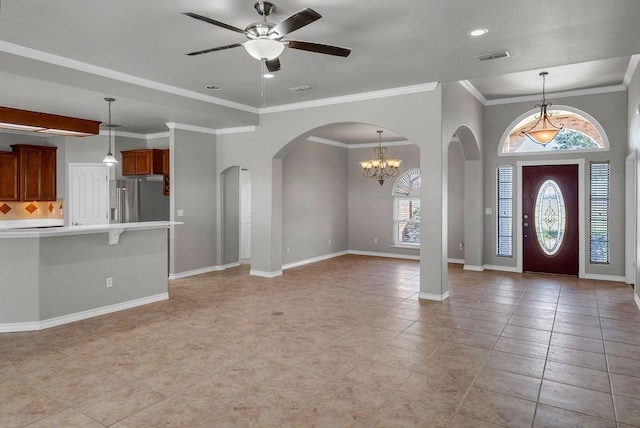 entryway featuring arched walkways, visible vents, ornamental molding, ceiling fan, and baseboards