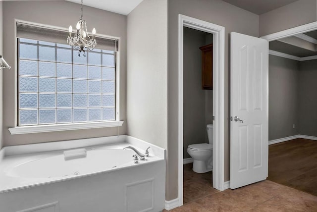 bathroom with baseboards, toilet, tile patterned floors, an inviting chandelier, and a bath